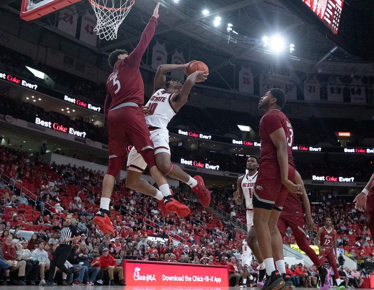 N.C. State’s Marcus Hill drives to the basket against Rider’s Jay Alvarez during the second half of the Wolfpack’s 89-63 win on Sunday, Dec. 22, 2024, at Lenovo Center in Raleigh, N.C.