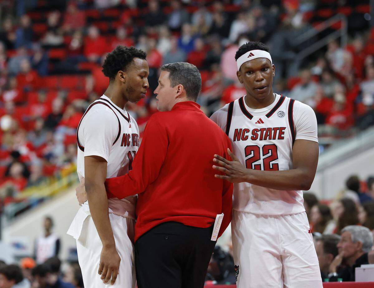 N.C. State head coach Will Wade talks with Quadir Copeland, left, as he exits the game late in the second half of the Wolfpack’s 76-61 loss to Virginia on Saturday, Jan. 3, 2026, at Lenovo Center in Raleigh, N.C.