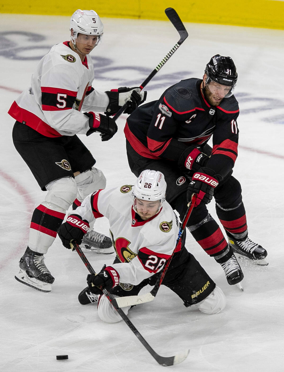 Ottawa’s Erik Brannstrom (26) blocks Carolina Hurricanes’ Jordan Staal (11) from a scoring attempt in front of the Ottawa goal during the second period on Tuesday, April 4, 2023 at PNC Arena in Raleigh, N.C.
