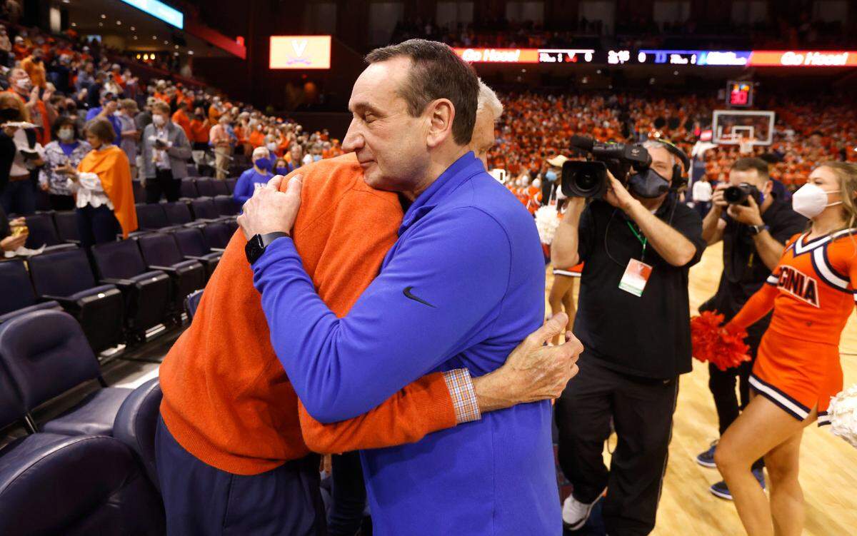 Duke head coach Mike Krzyzewski hugs former Virginia head coach Terry Holland before Duke’s game against Virginia at John Paul Jones Arena in Charlottesville, VA, Wednesday, Feb. 23, 2022.