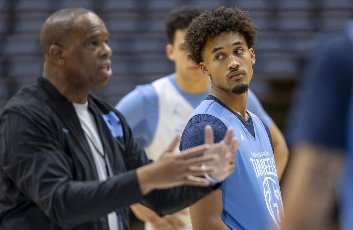 North Carolina senior guard Seth Trimble (7) listens to coach Hubert Davis during practice on Thursday, October 9. 2