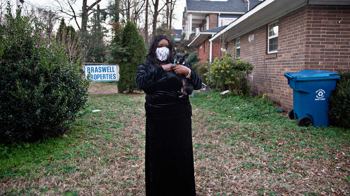 Janice Sanchez, 60, with her Chihuahua, Diamond, outside of her apartment building in Durham on Wednesday, Jan. 5, 2022. Sanchez and other residents had until Dec. 31 to leave their homes on North Buchanan Boulevard after Braswell Properties sold the complex in October. When this photo was taken, only six of the 12 families that live in the apartments had been able to find other housing.