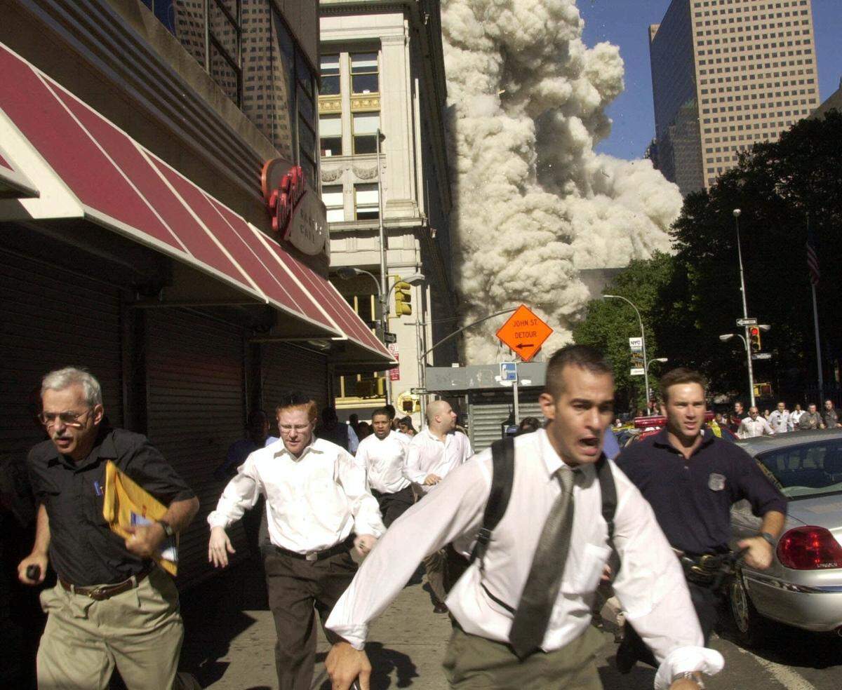 People run from the collapse of a World Trade Center tower in this Sept. 11, 2001 file photo.