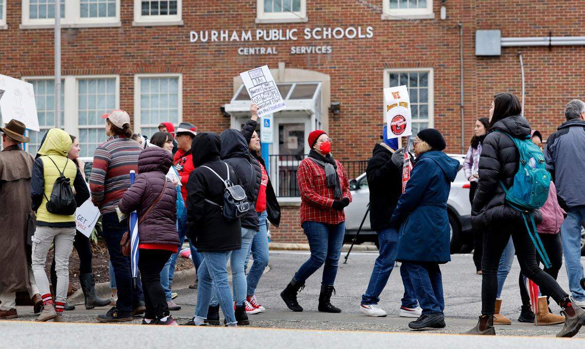 Protesters picket outside the Durham Public Schools administrative building in Durham, N.C., Wednesday, Jan. 31, 2024. Twelve Durham public schools were closed Wednesday as staff — furious about unresolved salary issues — called in sick to attend protests.