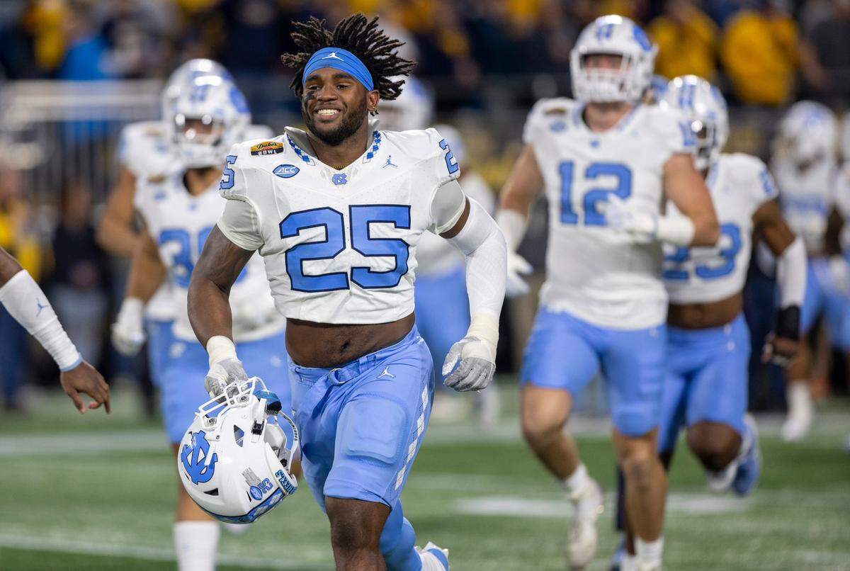 North Carolina senior Kaimon Rucker (25) enters the stadium for the Tar Heels’ game against West Virginia in the Duke’s Mayo Bowl on Wednesday, December 27, 2023 at Bank of American Stadium in Charlotte, N.C.
