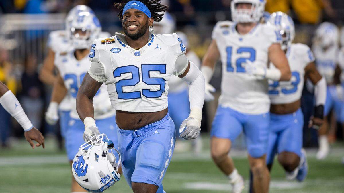 North Carolina senior Kaimon Rucker (25) enters the stadium for the Tar Heels’ game against West Virginia in the Duke’s Mayo Bowl on Wednesday, December 27, 2023 at Bank of American Stadium in Charlotte, N.C.