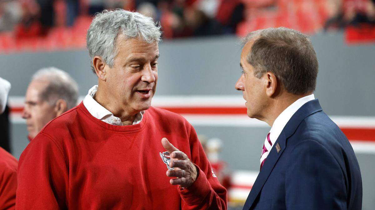 N.C. State athletics director Boo Corrigan, left, talks with ACC Commissioner Jim Phillips before the Wolfpack’s game against Miami at Carter-Finley Stadium in Raleigh, N.C., Saturday, Nov. 4, 2023.