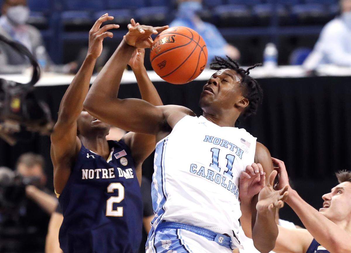 North Carolina’s Day’Ron Sharpe (11) pulls in the rebound from Notre Dame’s Trey Wertz (2) during the first half of UNC’s game against Notre Dame in the second round of the ACC Men’s Basketball Tournament in Greensboro, N.C., Wednesday, March 10, 2021.