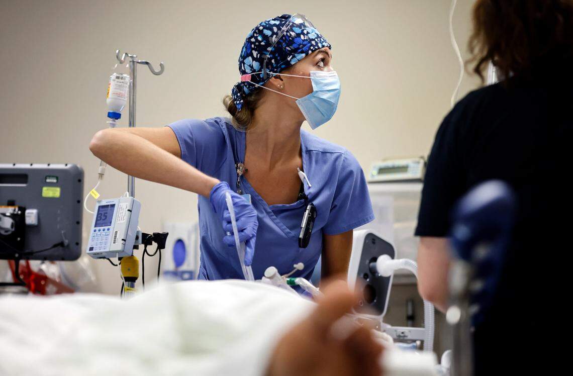 Emergency department nurse checks a monitor while caring for a patient brought in by EMS at UNC REX Hospital in Raleigh, N.C., Friday, October 1, 2021.