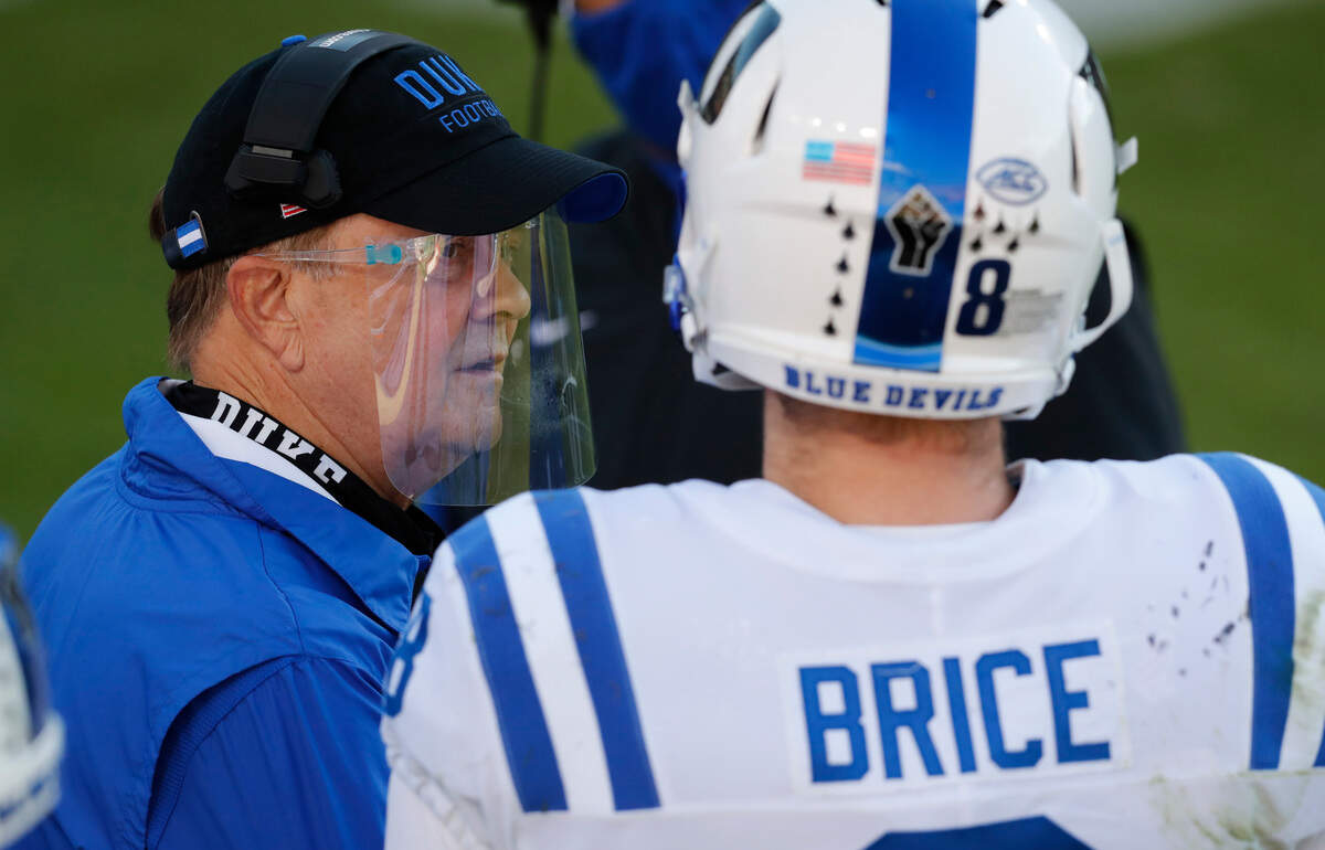 Duke head coach David Cutcliffe talks with quarterback Chase Brice (8) during the first half of N.C. State’s game against Duke at Carter-Finley Stadium in Raleigh, N.C., Saturday, Oct. 17, 2020.