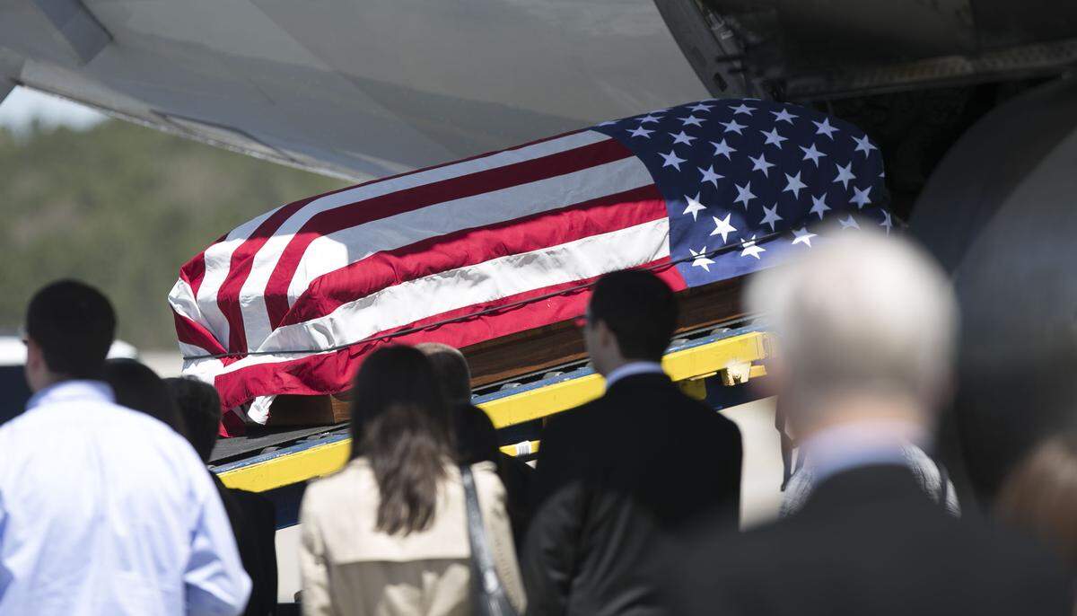 The remains of Col. Edgar Felton Davis, who was shot down over Laos in 1968, received a hero's welcome at Raleigh-Durham International Airport on Thursday. He will be buried in his hometown of Goldsboro on Friday.