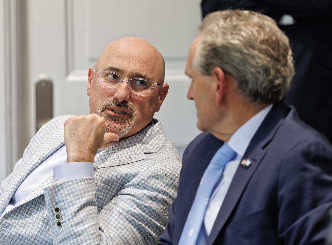 Incoming North Carolina athletic director Steve Newmark speaks with athletic director Bubba Cunningham following a meeting of the UNC Board of Trustees on Tuesday, April 7, 2026, at South Building.