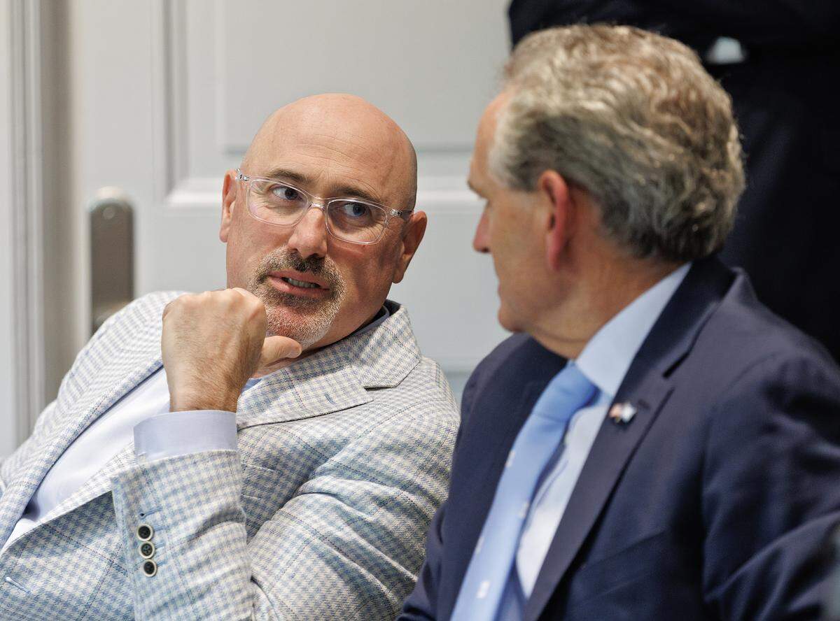 Incoming North Carolina athletic director Steve Newmark speaks with athletic director Bubba Cunningham following a meeting of the UNC Board of Trustees on Tuesday, April 7, 2026, at South Building. 