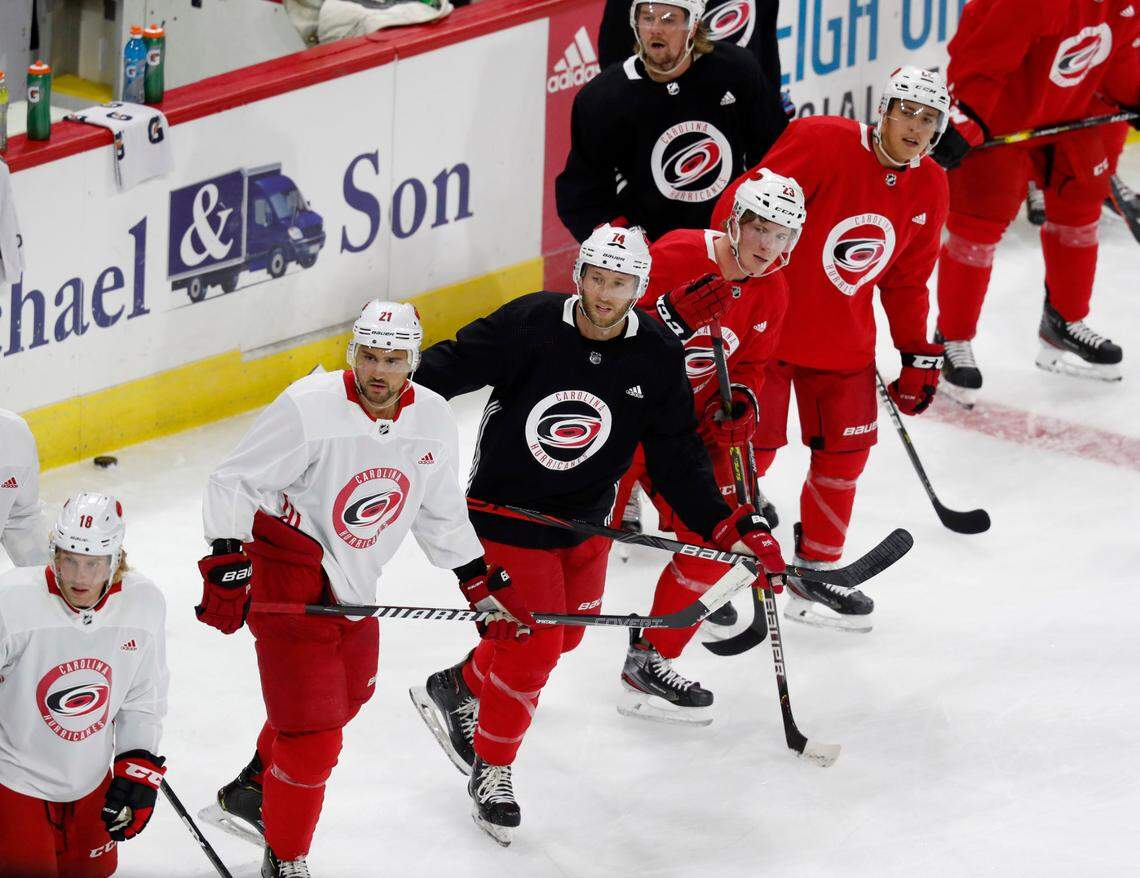 From left, Carolina’s Nino Niederreiter (21), Jaccob Slavin (74), and Brock McGinn (23) get ready to do drills during the Carolina Hurricanes’ on-ice workouts at PNC Arena in Raleigh, N.C., Monday, July 13, 2020.