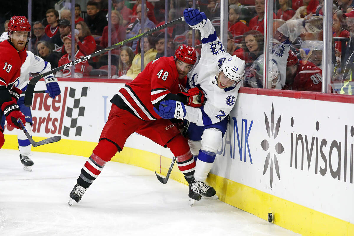 Carolina Hurricanes’ Jordan Martinook (48) collides with Tampa Bay Lightning’s Carter Verhaeghe (23) during the first period of an NHL hockey game in Raleigh, N.C., Sunday, Oct. 6, 2019. (AP Photo/Karl B DeBlaker)