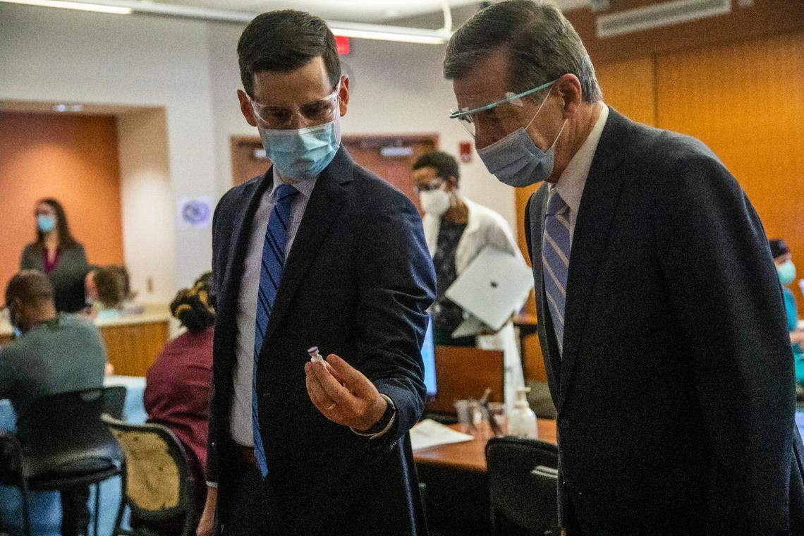 Dr. Dan Schenkat shows Gov. Roy Cooper a vile containing Covid-19 vaccine at UNC Health in Chapel Hill, NC Thursday, Dec. 7, 2020 where frontline healthcare workers are among some of the first recipients of the Pfizer COVID-19 vaccine.