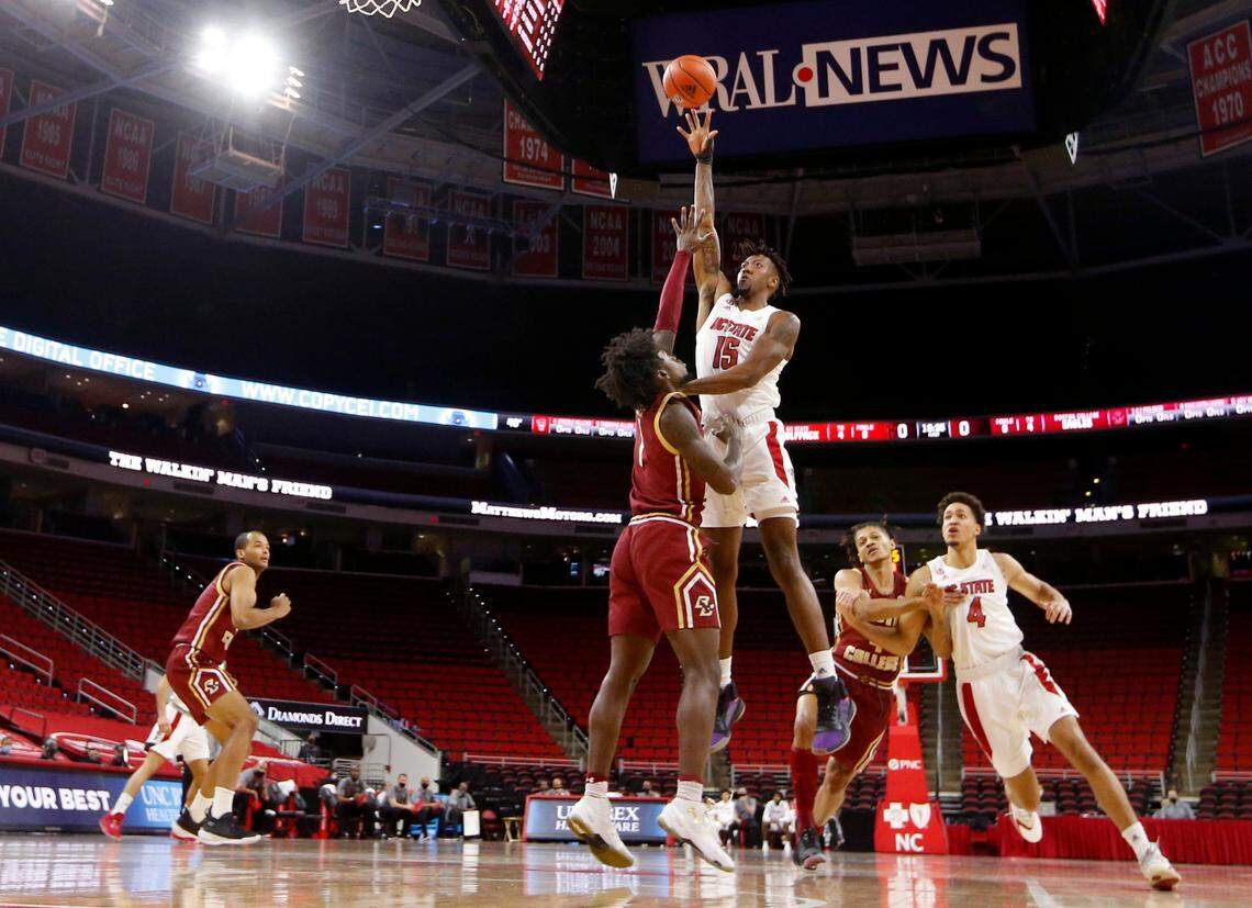 N.C. State’s Manny Bates (15) shoots as Boston College’s CJ Felder (1) defends during N.C. State’s 79-76 victory over Boston College at PNC Arena in Raleigh, N.C., Wednesday, December 30, 2020.