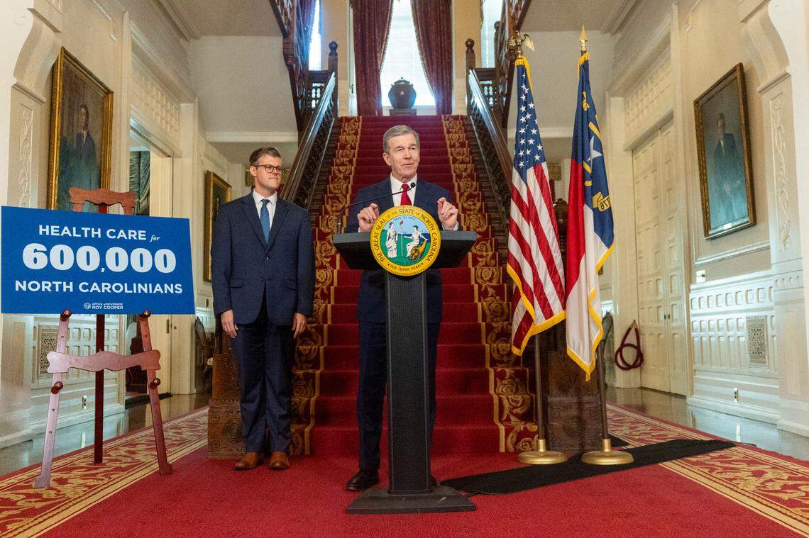 Gov. Roy Cooper announces a Medicaid expansion launch date of Dec. 1 as Secretary of Health and Human Services Kody Kinsley looks on during a press conference Monday, Sept 25, 2023 at the Executive Mansion in Raleigh.