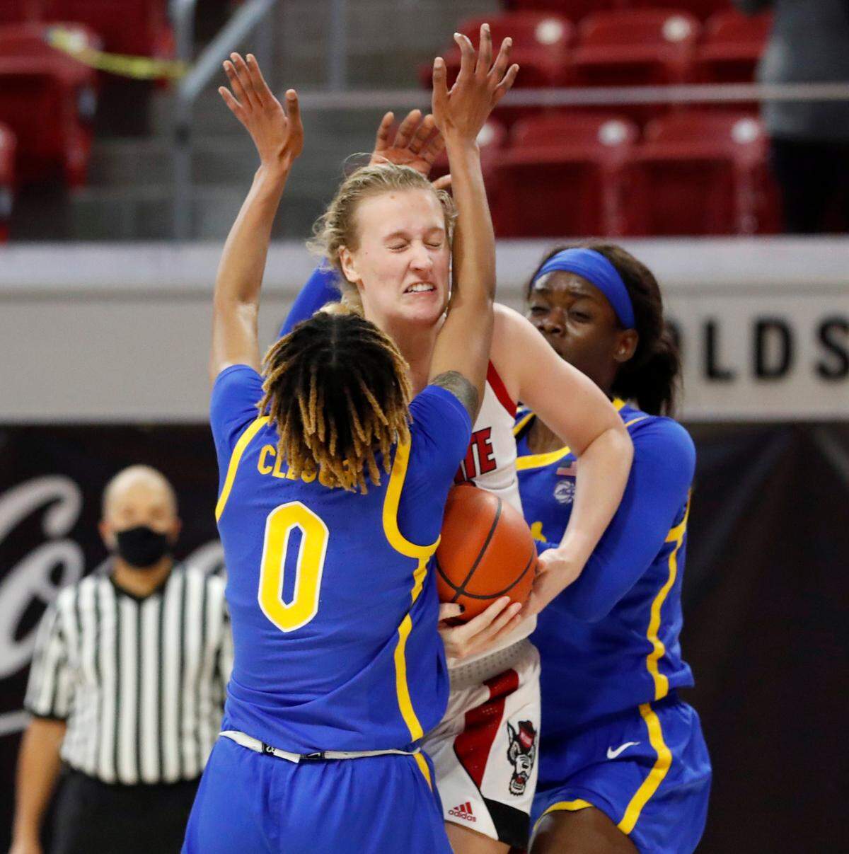 N.C. State’s Elissa Cunane (33) pulls in the rebound from Pittsburgh’s Sandrine Clesca (0) and Rita Igbokwe (23) during the first half of N.C. State’s game against Pittsburgh at Reynolds Coliseum in Raleigh, N.C., Thursday, February 25, 2021.