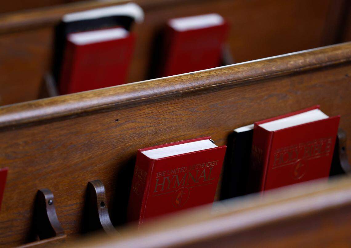 Hymnals and Bibles sit in pews during a service at Elizabeth Street United Methodist Church on Sunday, July 31, 2022, in Durham, N.C.