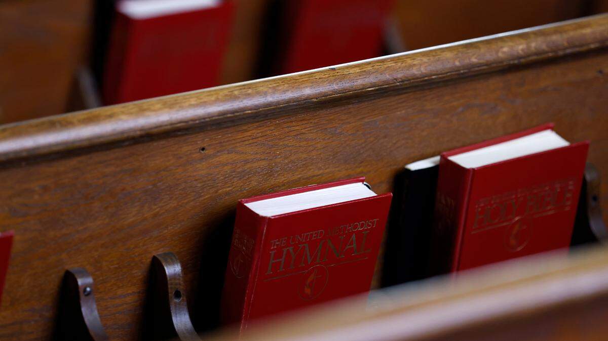 Hymnals and Bibles sit in pews during a service at Elizabeth Street United Methodist Church on Sunday, July 31, 2022, in Durham, N.C.