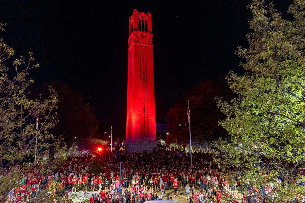 NC State fans celebrate at the Memorial Belltower on campus after the men’s basketball team’s 76-64 win over Duke to advance to the Final Four in the NCAA Men’s Division I Basketball Tournament on Sunday, March 31, 2024.