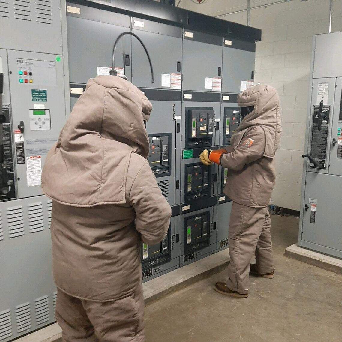 Workers install a new circuit breaker at Raleigh-Durham International Airport on Friday, Nov. 12, after water leaked into a switchgear, knocking out power to large parts of the airport.