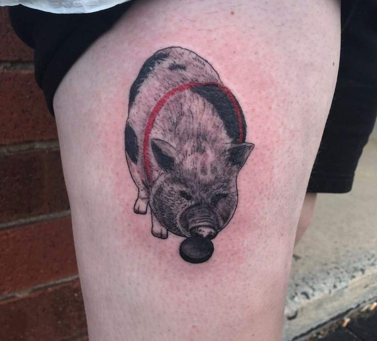 Leah Adams shows her Hamilton the pig tattoo, which she got in 2019 to support the Carolina Hurricanes.
