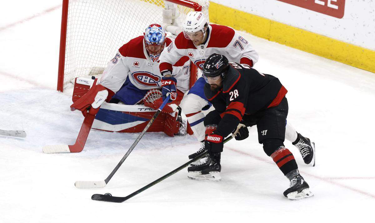 Carolina's William Carrier (28) works around Montréal's Zachary Bolduc (76) in the second period of the Hurricanes’ game against the Canadiens in game two of the Eastern Conference Finals at the Lenovo Center in Raleigh, N.C., Saturday, May 23, 2026.