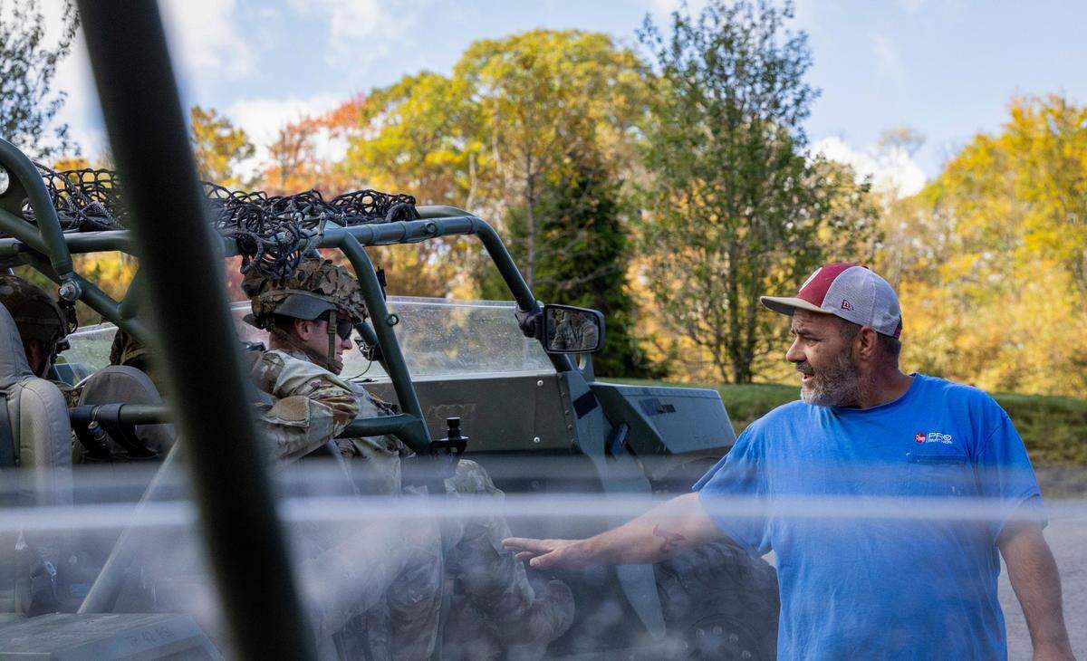 A Maggie Valley resident thanks soldiers of the 101st Airborne Division Air Assault, 2nd Brigade Combat Team, from Fort Campbell, Kentucky, who were delivering water, food, toiletries, and other aid to residents in the Soco Gap community in Maggie Valley on Tuesday, October. 8, 2024. The team has been using the Maggie Valley Pavilion and Town Hall as a distribution base for relief efforts in the town following Tropical Storm Helene.