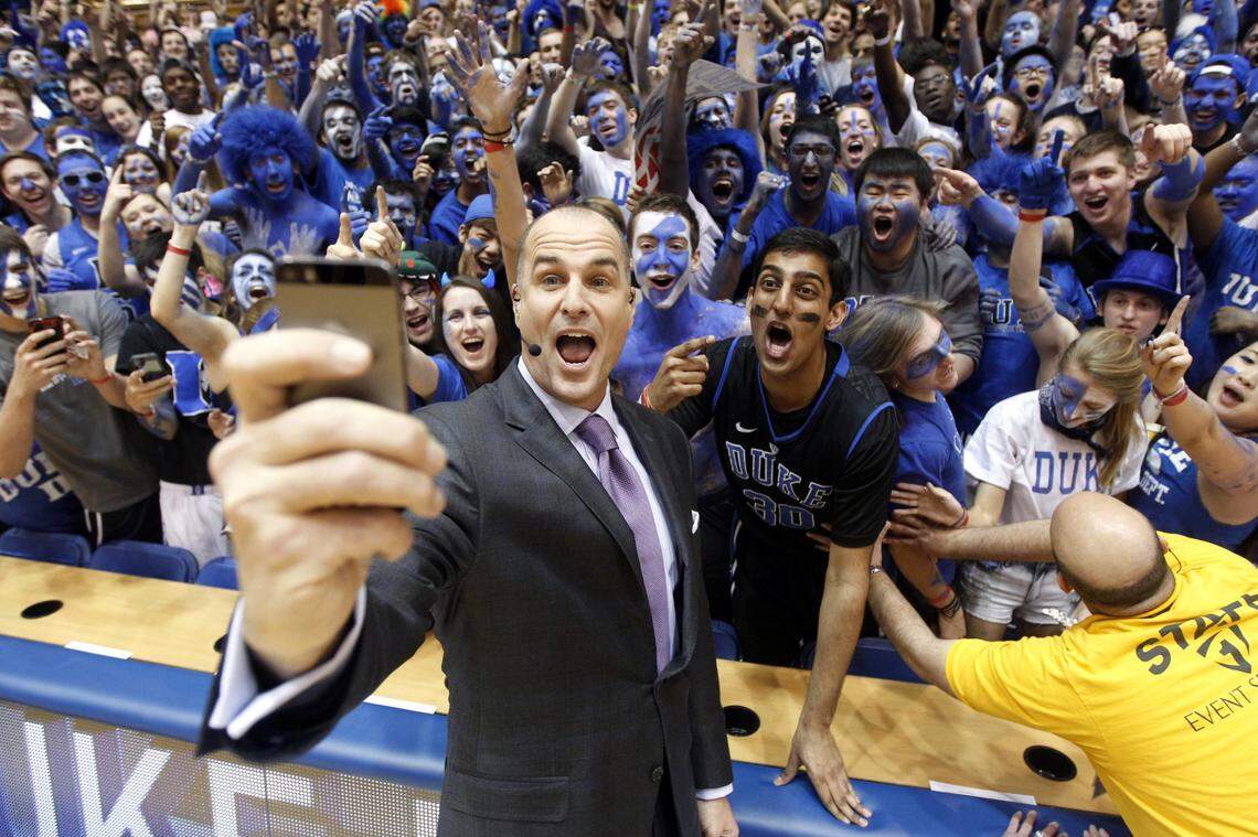 ESPN basketball analyst and former Duke player Jay Bilas takes a selfie in Cameron Indoor Stadium in front of the Cameron Crazies.