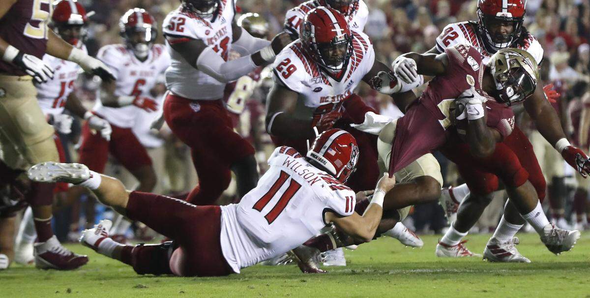 N.C. State linebacker Payton Wilson (11) tackles Florida State running back Khalan Laborn (4) during the first half of N.C. State’s game against Florida State at Doak Campbell Stadium in Tallahassee, Fla., Saturday, Sept. 28, 2019.