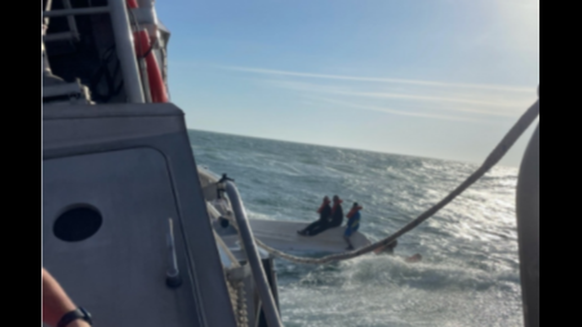 The U.S. Coast Guard arrived to find three people riding atop the capsized boat and two others in the water.