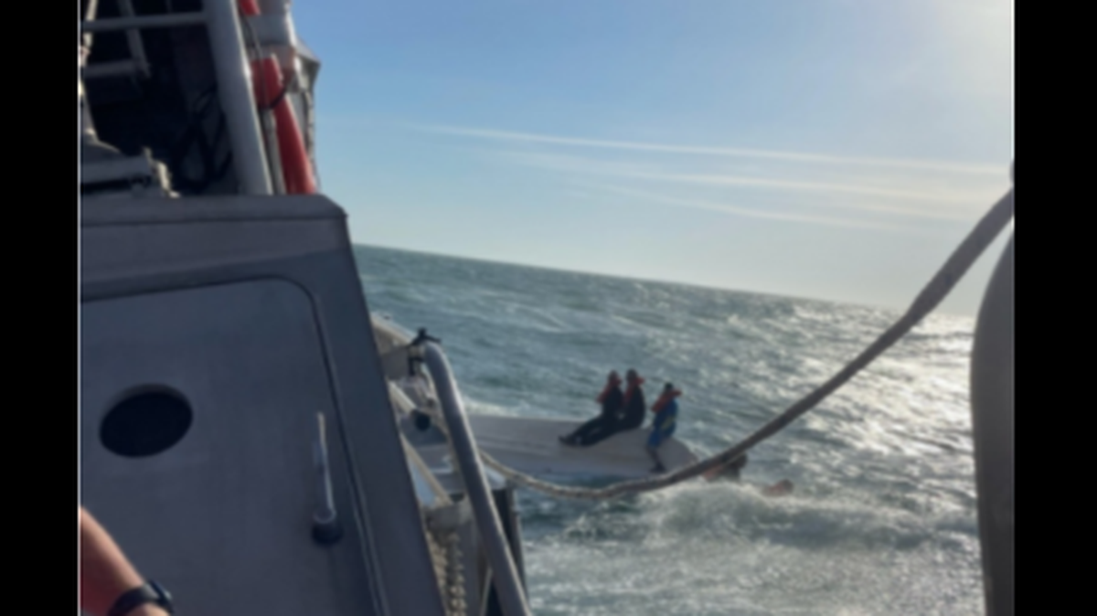 The U.S. Coast Guard arrived to find three people riding atop the capsized boat and two others in the water.
