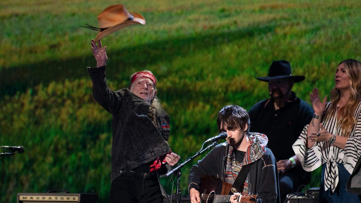 Willie Nelson tosses his hat into the crowd after the finale at Farm Aid at Raleigh, N.C.’s Coastal Credit Union Music Park at Walnut Creek, Saturday, Sept. 24, 2022.