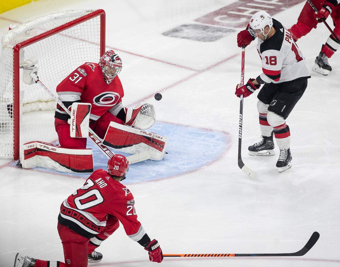Carolina Hurricanes goalie Frederik Andersen (31) deflects a scoring attempt by the New Jersey Devils Ondrej Palat (18) in overtime during Game 5 of their second round Stanley Cup playoff series on Thursday, May 11, 2023 at PNC Arena in Raleigh, N.C. Andersen made 27 saves in the Hurricanes’ 3-2 overtime victory.
