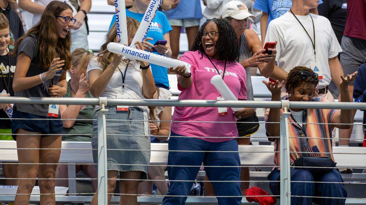 From left, Marlowe Bellerjeau, Darcy Bellerjeau, Faith Crooks and Christine Shearer cheer on the 2024 United States Olympic Swim Team during its open practice on Saturday, July 6, 2024 at the Triangle Aquatic Center in Cary, N.C.