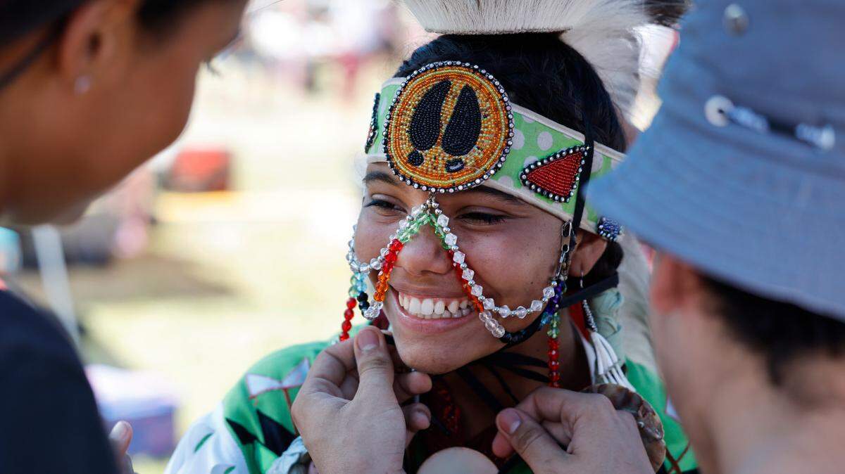Lily Hunt of Fayetteville, a member of the Lumbee Tribe, smiles as she prepares for a switch dance during the Dix Park Inter-Tribal Pow Wow in Raleigh, N.C., Saturday, August 26, 2023.