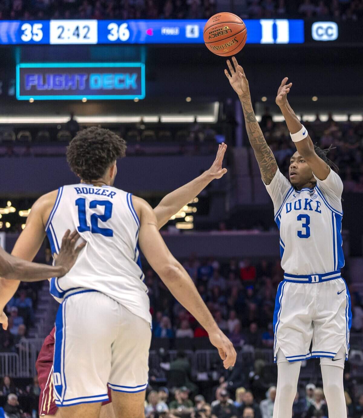 Duke forward Isaiah Evans (3) launches a three-point shot in the first half against Florida State on Thursday, March 12, 2026, during the quarterfinals of the ACC Tournament at Spectrum Center in Charlotte, N.C. Evans scored 22 points in the first half.