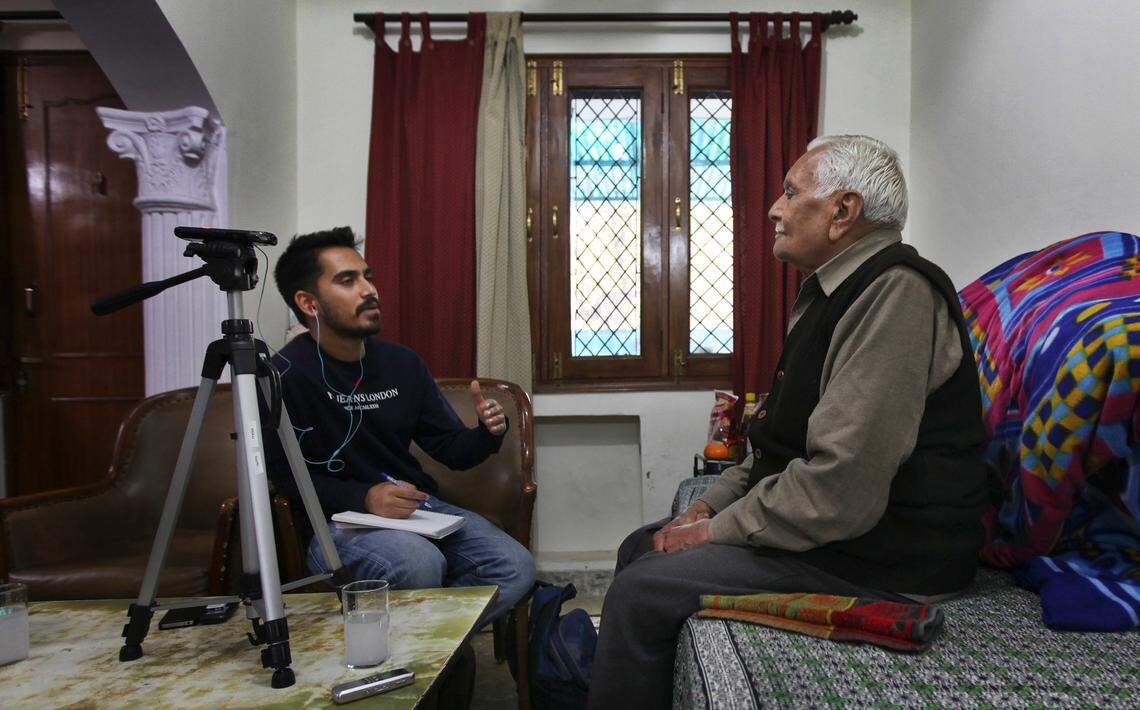 In this 2015 photo, Prakhar Joshi, left, asks a question to 86-year old Desh Raj Kalra during an interview at his residence in New Delhi, India. Joshi spent 15 months crisscrossing the country interviewing about 150 people to record oral histories, including the partition of India.