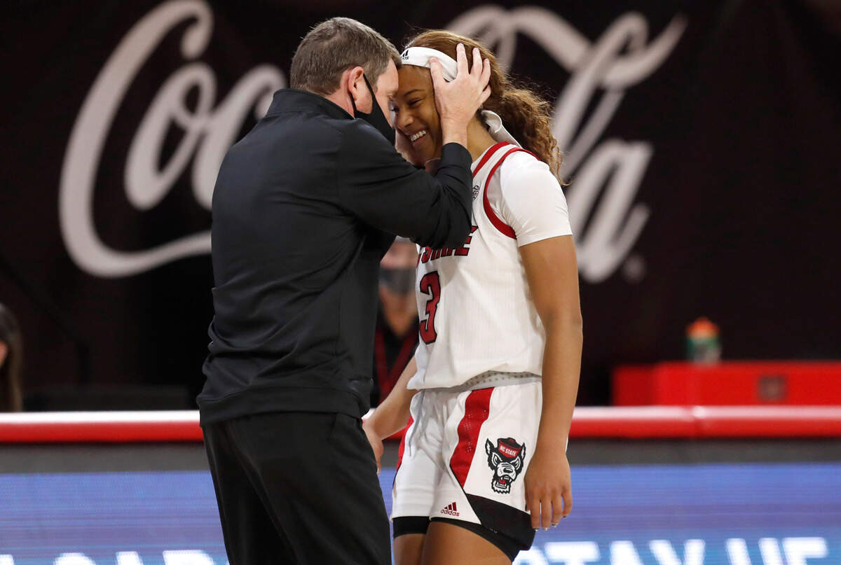 N.C. State’s Kai Crutchfield (3) is congratulated by Houston Fancher, Director of Operations and Player Development, after N.C. State’s 89-87 victory over Virginia Tech at Reynolds Coliseum in Raleigh, N.C., Sunday, January 24, 2021.