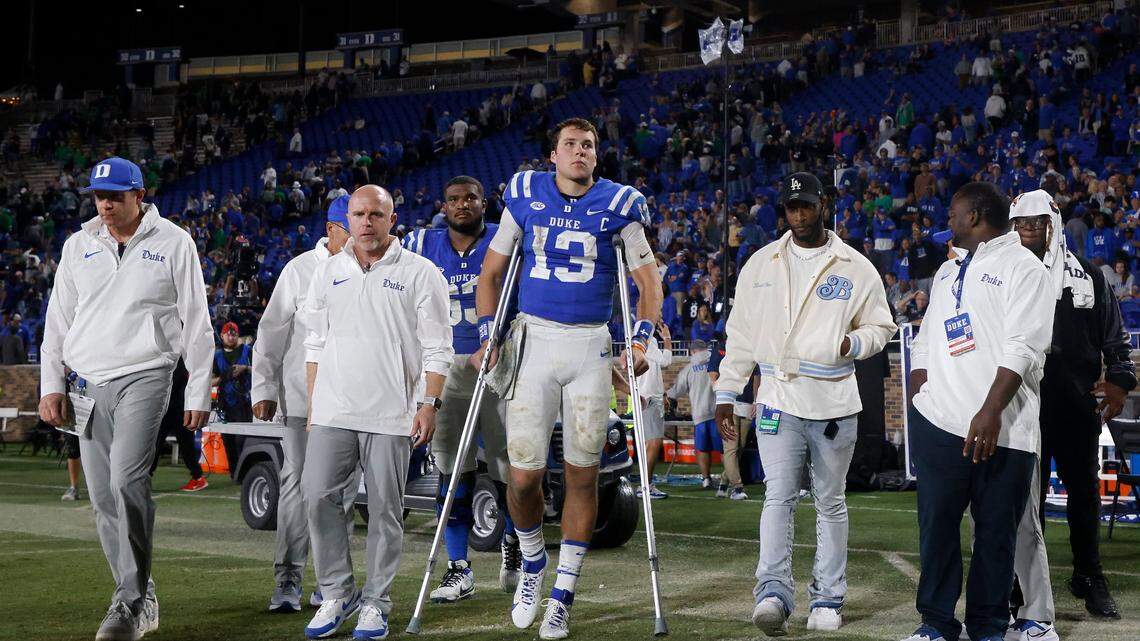 Duke’s Riley Leonard leaves the field on crutches following the Blue Devils’ 21-14 loss to Notre Dame at Wallace Wade Stadium on Saturday, Sept. 30, 2023, in Durham, N.C.