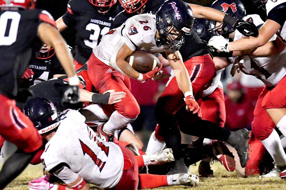 Apex Friendship running back Jaden Avery (26) leaps for the first down off a 4th down conversion against Middle Creek late in the fourth quarter. The Middle Creek Mustangs and the Apex Friendship Patriots met in a football game in Cary, N.C. on October 25, 2024.
