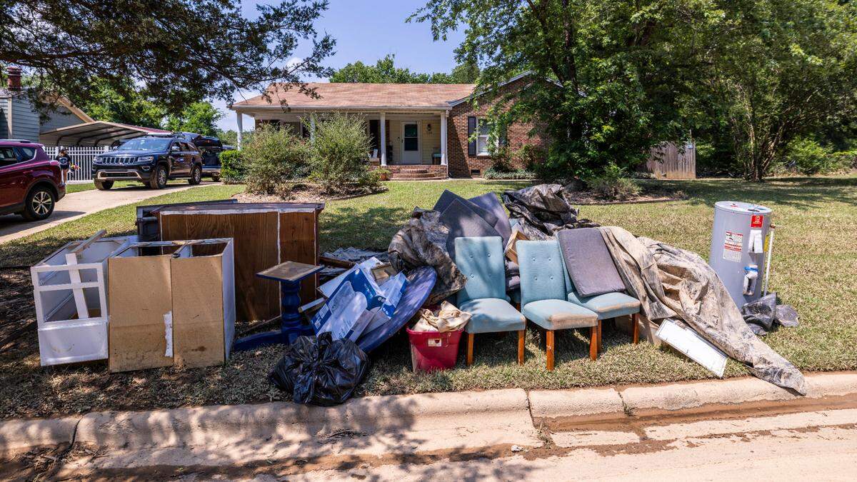 Flood-damaged household items sit at the curb in front of a home on Rippling Stream Road in Durham’s Old Farm neighborhood near the Eno River on Wednesday, July 9, 2025, after flash flooding caused by Tropical Storm Chantal.