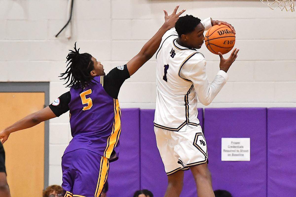 Broughton's Jordan page (1) recovers the rebound away from Wilson's Jaden Gerald (5) during the first half. The Broughton Capitals and the Wilson (SC) Tigers played in the first round of the John Wall Holiday Tournament on December 26, 2025.