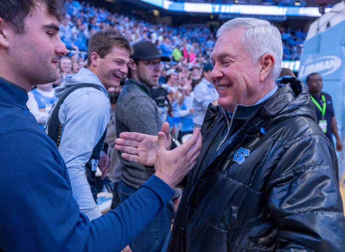 North Carolina coach Mack Brown greets former quarterback Sam Howell who was seated court side with quarterback Drake Maye prior to the Duke vs North Carolina game on Saturday, February, 3, 2024 at the Dean E. Smith Center in Chapel Hill, N.C.