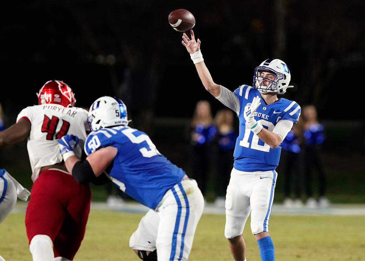 Duke quarterback Gunnar Holmberg (12) passes against Louisville during the first half of an NCAA college football game in Durham, N.C., Thursday, Nov. 18, 2021.