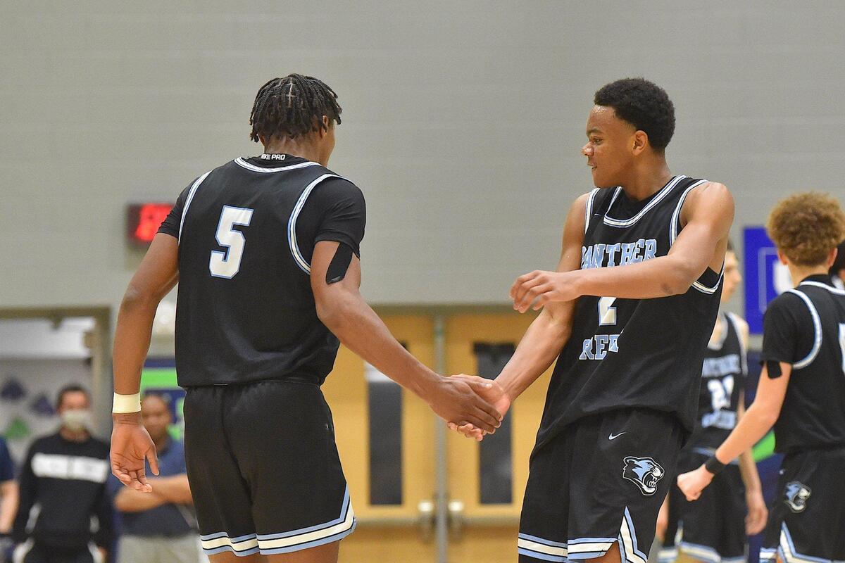 Panther Creek’s Tyler Thompson (5) celebrates with Amari Odom (2) after a play in the second half. The Panther Creek Catamounts and the Cleveland Rams met in the NCHSAA 4A Boys East Regional Finals in Cary, N.C. on March 5, 2022.