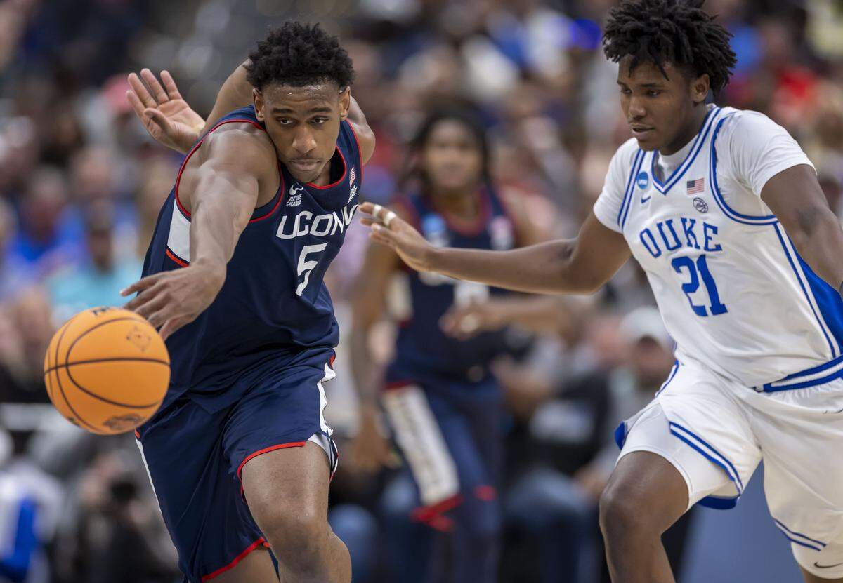 Connecticut forward Tarris Reed Jr. (5) makes a steal from Duke center Patrick Ngongba II (21) in the second half on Sunday, March 29, 2026, in the NCAA East Regional Championship, at Capital One Arena in Washington, D.C.
