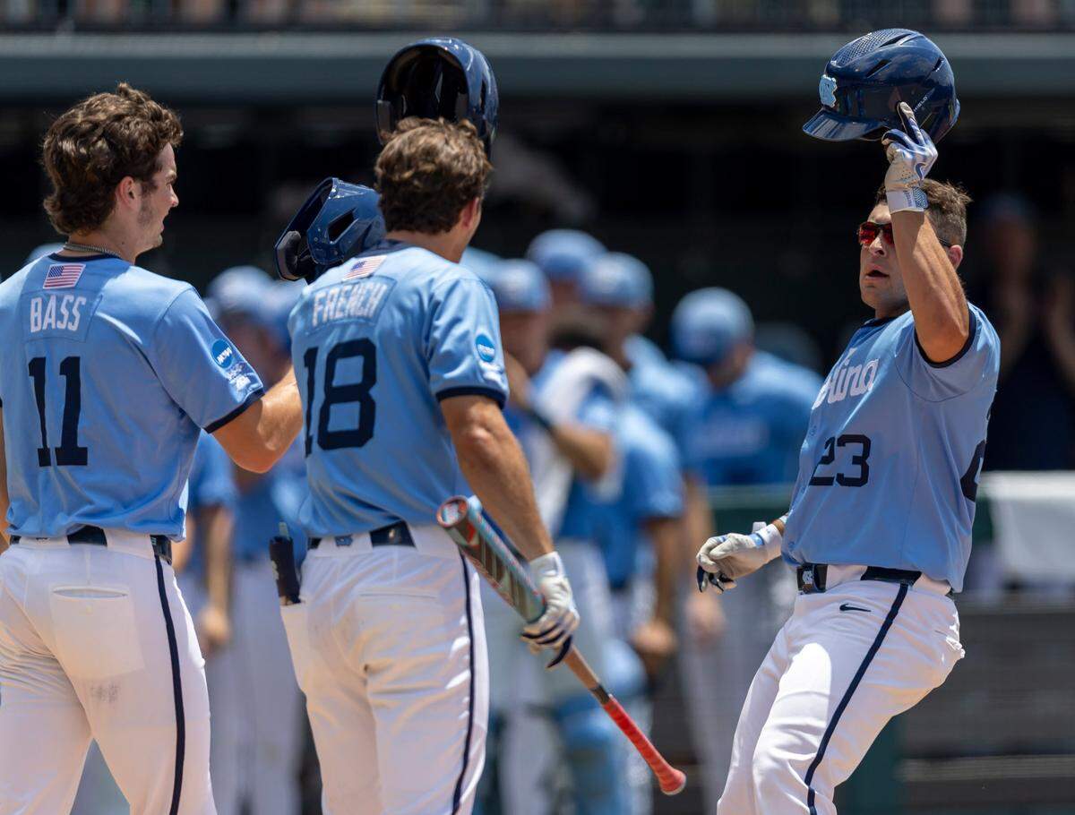 North Carolina designated hitter Sam Angelo (23) is greeted at home plate after connecting for a 2 RBI home run in the second inning to give the Tar Heels a 2-1 lead over Arizona during the NCAA Super Regional on Saturday, June 7, 2025 at Boshamer Stadium in Chapel Hill, N.C.